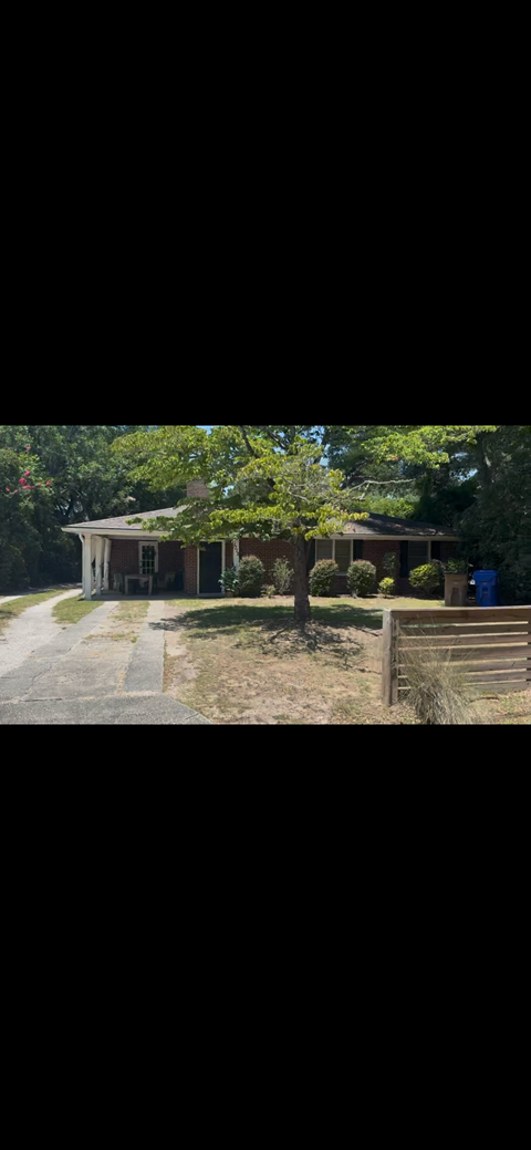 A house with a tree in front of it.