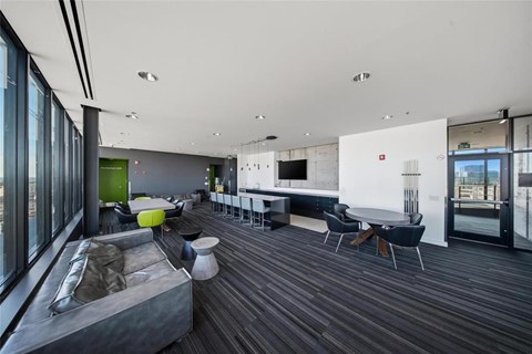 A modern living room with a grey sofa and a white table.