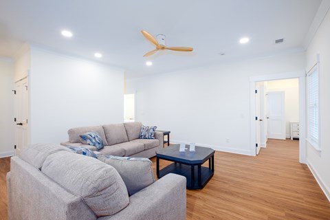 A living room with a grey couch and a blue coffee table.