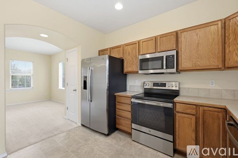 A kitchen with wooden cabinets and stainless steel appliances.