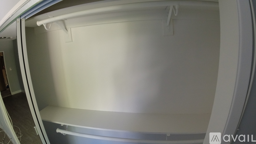 A white refrigerator with a shelf inside.