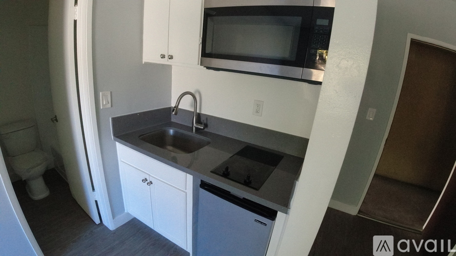 A small kitchen with a sink and a microwave.