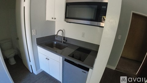 A small kitchen with a sink and a microwave.