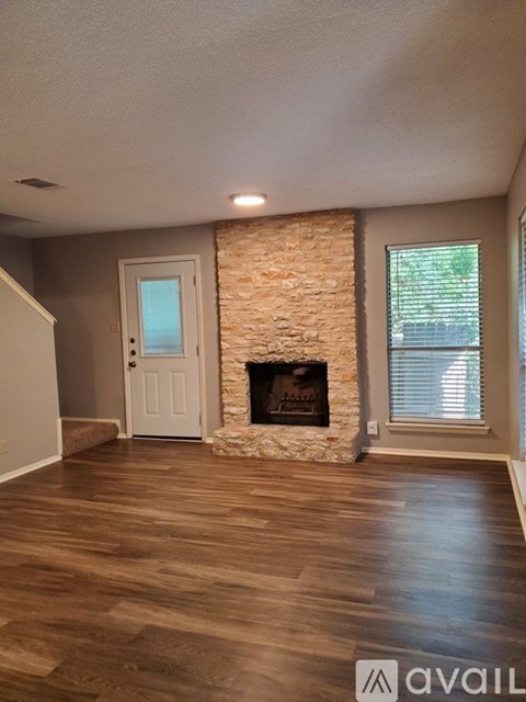 A living room with a fireplace and a door.