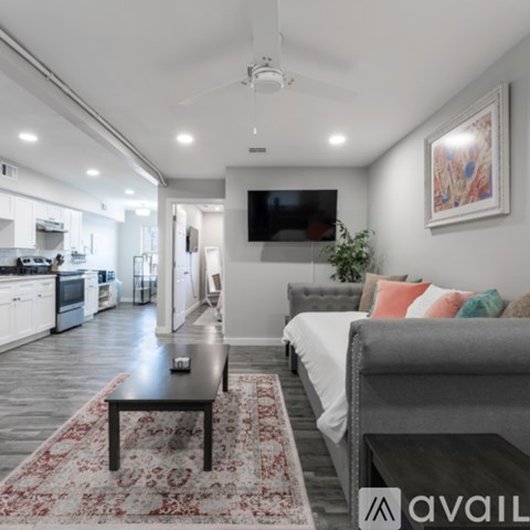 A modern living room with a grey couch and a coffee table in the center.