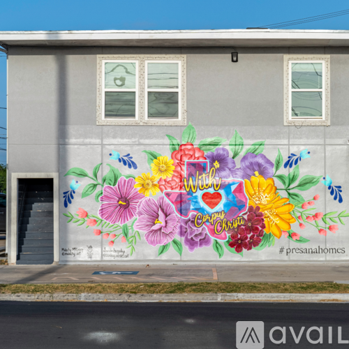 A mural on a building wall with flowers and the words "with love" and "carry on" written on it.