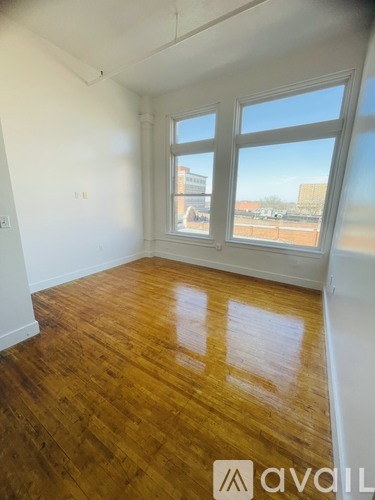 A room with wooden floors and white walls.