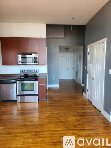 A kitchen with wooden cabinets and a stainless steel oven.
