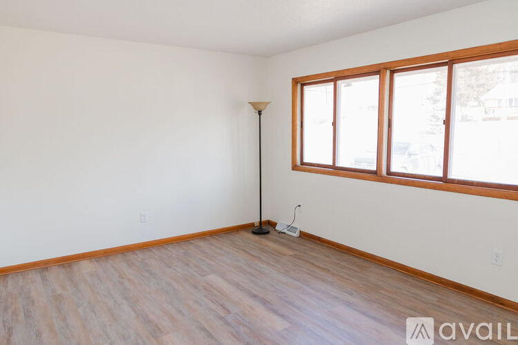 A room with a wooden floor and a window.