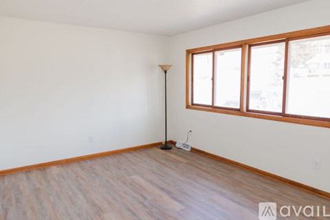 A room with a wooden floor and a window.