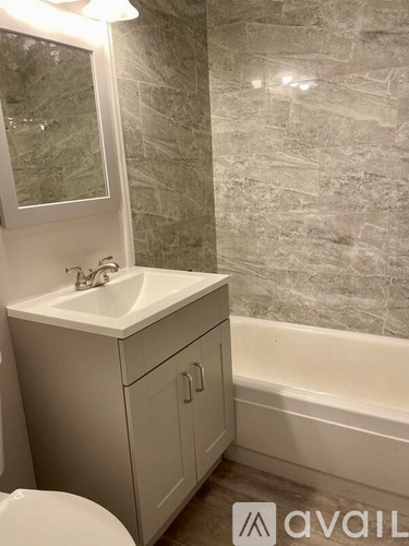 A bathroom with a sink, toilet, and bathtub.