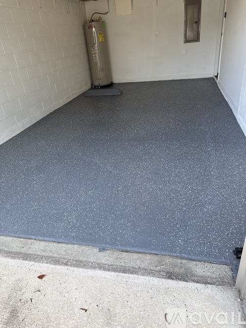 A room with a grey floor and a white wall.