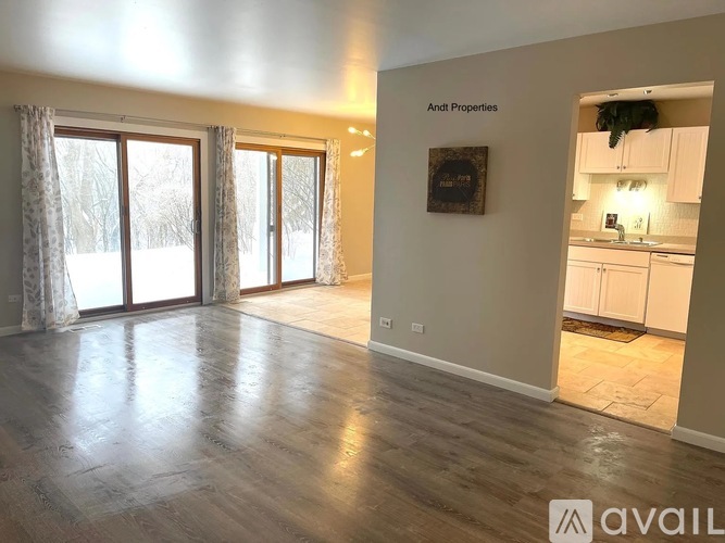A spacious room with a sign that says "Andi Properties" on the wall.