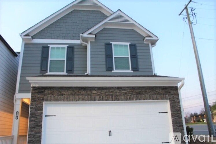 A two-story house with a garage door.