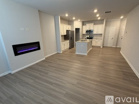 A kitchen with a white island and a refrigerator.