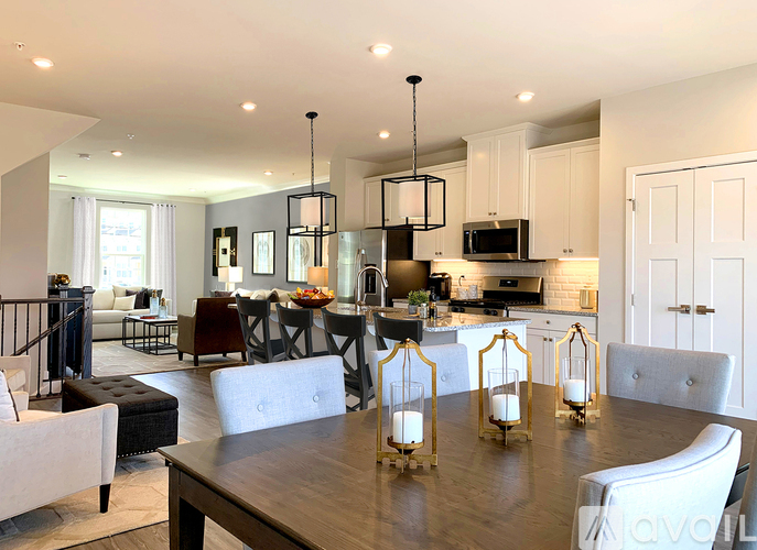 A modern kitchen with a dining table and chairs.