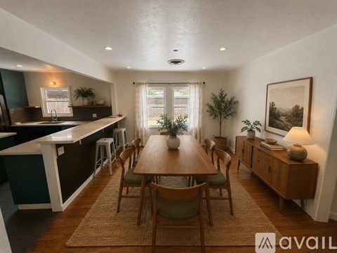 A dining room with a wooden table and chairs.