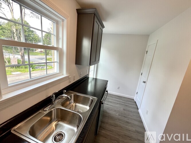 A kitchen with a double sink and a window.