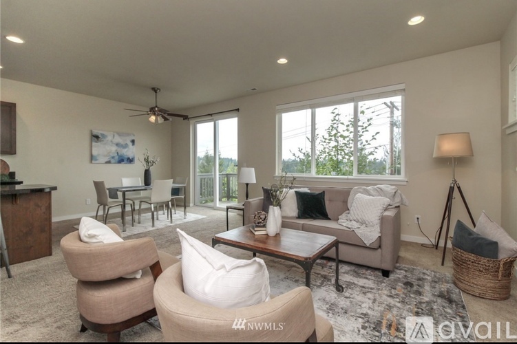 A living room with a sofa, armchairs, and a coffee table.