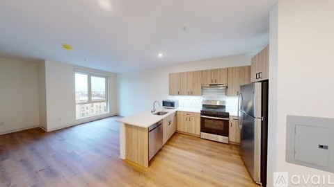 A kitchen with wooden cabinets and a refrigerator.