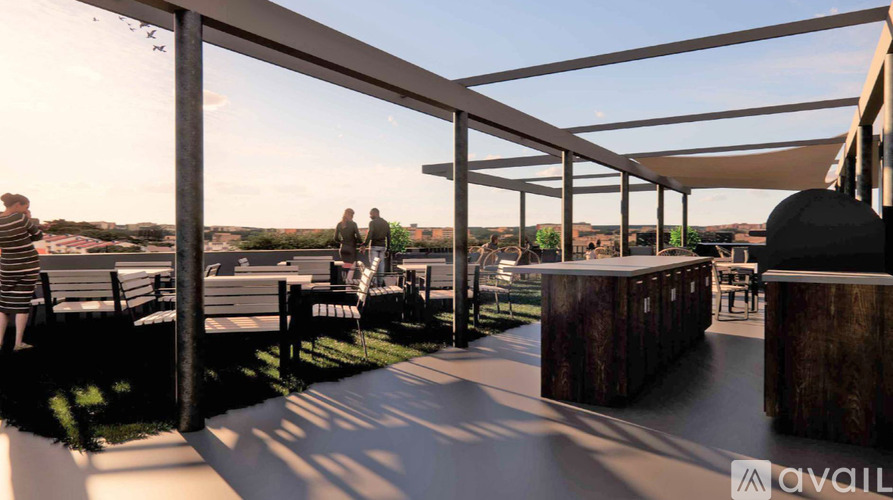 A modern outdoor seating area with people walking around.