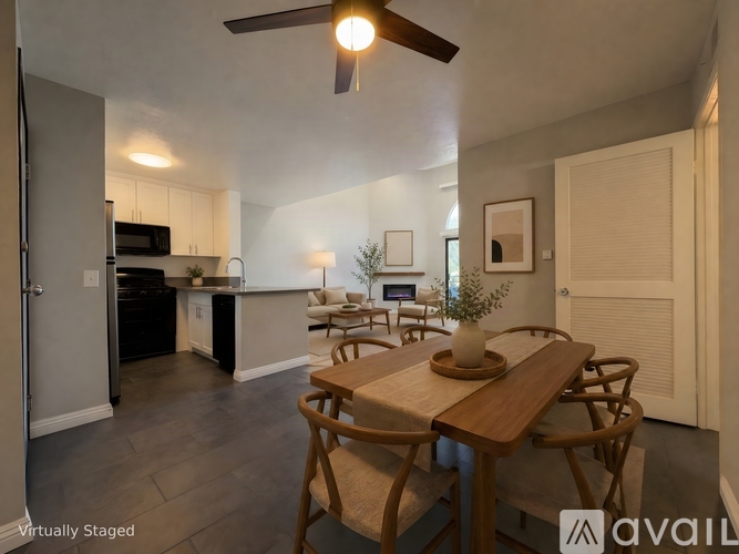 A dining room with a wooden table and chairs.