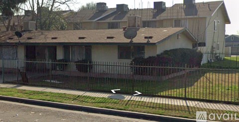 A house with a black fence in front of it.