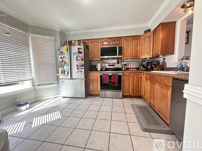 A kitchen with wooden cabinets and a white refrigerator.