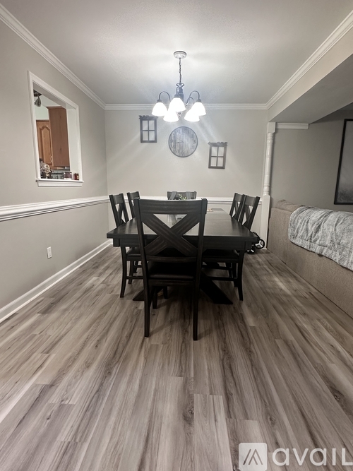 A dining room with a table set for four.
