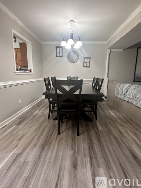 A dining room with a table set for four.