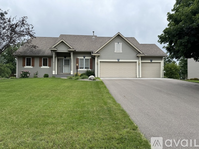 A house with a grey roof and a garage door.