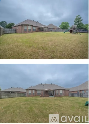 Two houses with a fence and a playground in the backyard.