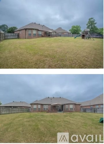 Two houses with a fence and a playground in the backyard.