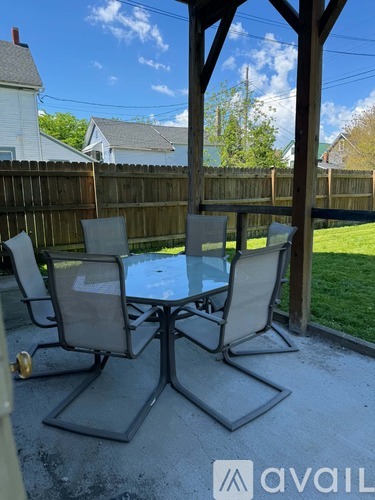 A patio table with four chairs is set up on a patio.