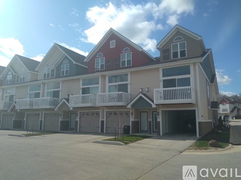 A row of houses with a sign that says "AVAIL" in front of them.