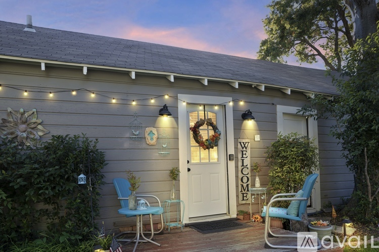 A house with a white door and a sign that says "Welcome" on the front porch.
