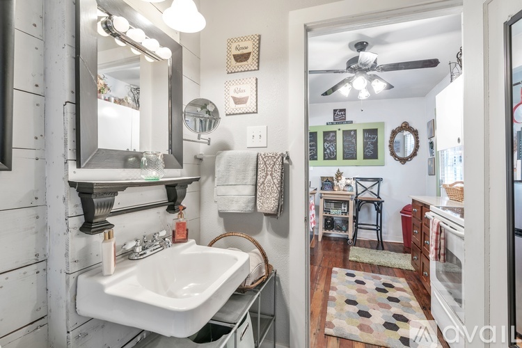 A bathroom with a white sink and a mirror above it.