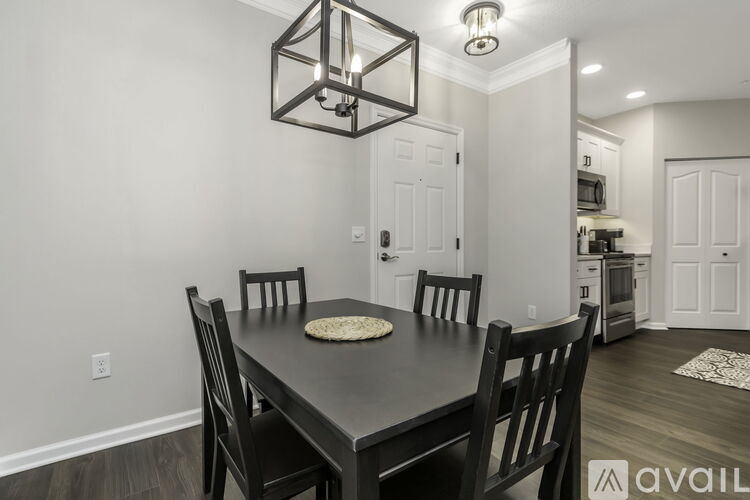 A dining room with a table set for four.