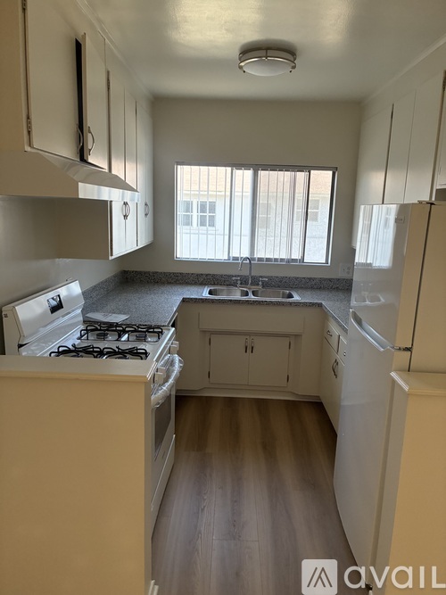 A kitchen with a stove, oven, and refrigerator.