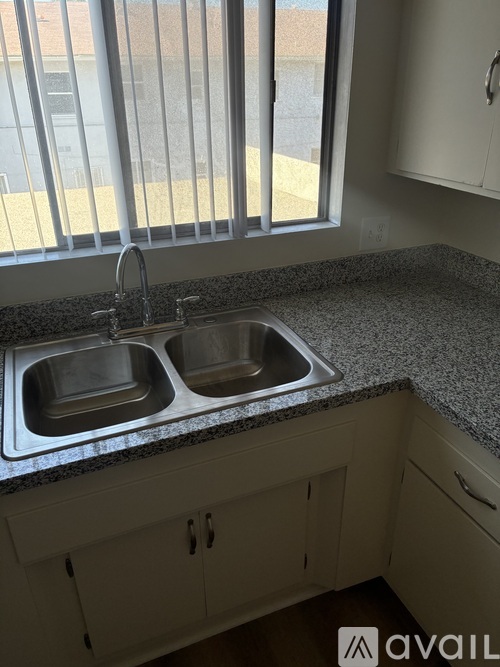 A kitchen with two sinks and a window.