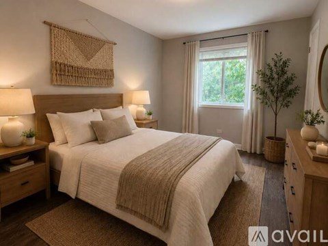 A bedroom with a large bed and a window with curtains.