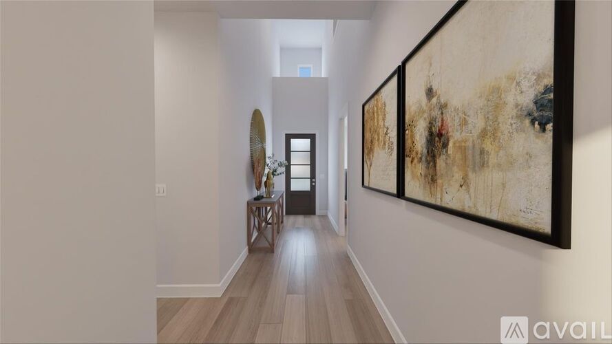 A hallway with a painting on the wall and a mirror on the left.