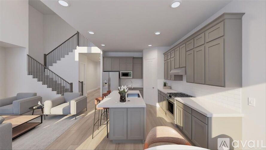 A modern kitchen with a dining area and a staircase.