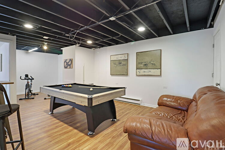 A room with a pool table and a couch.