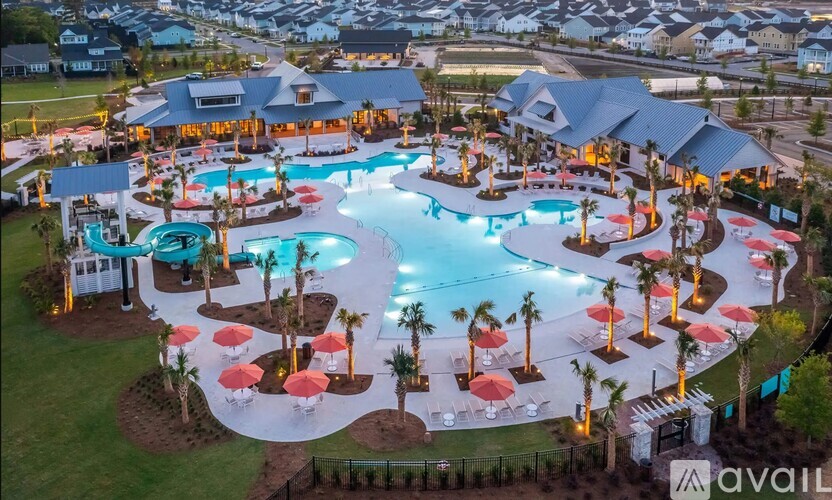 A large outdoor pool area with a hot tub and lounging areas.