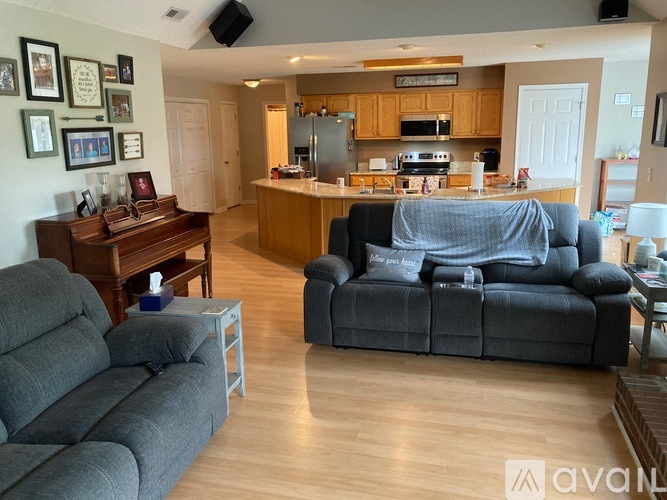 A living room with a grey couch and a wooden table.