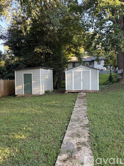 Two sheds are located in a grassy area.