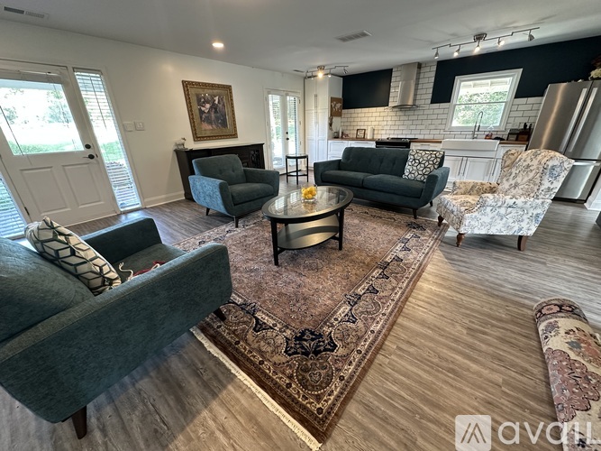 A living room with a grey couch, a coffee table, and a rug.