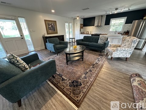 A living room with a grey couch, a coffee table, and a rug.