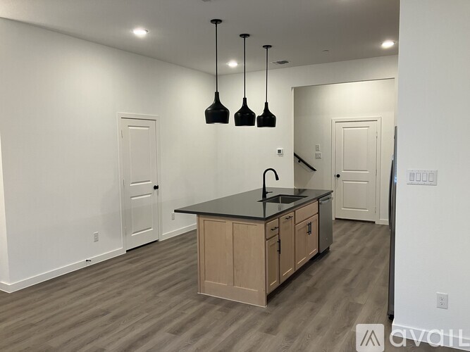 A kitchen with a black countertop and wooden cabinets.